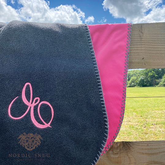 Picnic Snug Main Image Blanket Charcoal with Cerise Backing over fence